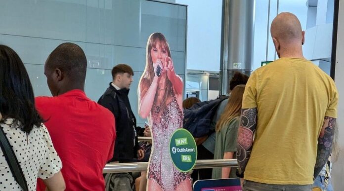 Taylor Swift fans are FREAKING Out over Travis Kelce’s glow up at the Airport for the Eras Tour in Dublin.