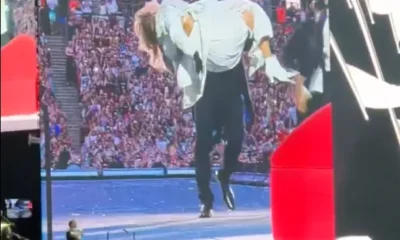 He's her No1 fan! Taylor Swift's Superbowl-winning fella Travis Kelce PERFORMS on stage with her at Wembley - carrying her across the stage then fanning her to the delight of the crowd